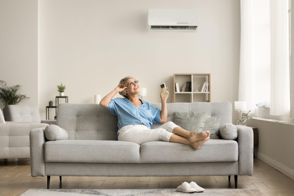 Split-system air conditioning unit above blonde woman in Reedy Creek home